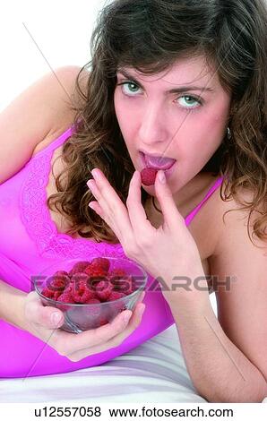 Woman, Brown hair, Ponytail, Beauty, Pink undershit, Red Currant Berry, Eating View Large Photo Image Stock Photo - Woman, Brown hair, Ponytail, Beauty, Pink undershit, Red Currant Berry, Eating. Fotosearch