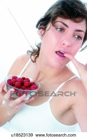 Woman, Brown hair, Ponytail, Beauty, White undershit, Red Currant Berry, Eating View Large Photo Image Stock Photo - Woman, Brown hair, Ponytail, Beauty, White undershit, Red Currant Berry, Eating. Fotosearch