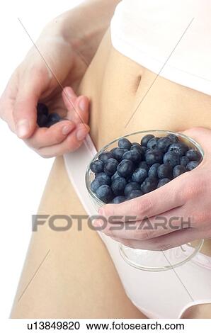 Stock Image - Woman, Beauty, White undershit, Fruit, Blueberry, Bowl, Bust. Fotosearch