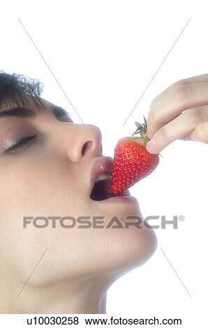 Stock Photo - Woman, Brown Hair, Beauty, Eating, Fruit, Strawberry, Mouth. Fotosearch