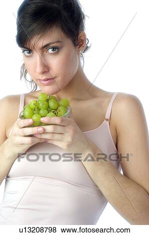 Stock Photo - Woman, Brown Hair, Beauty, White undershit, Eating, Fruit, Grapes. Fotosearch