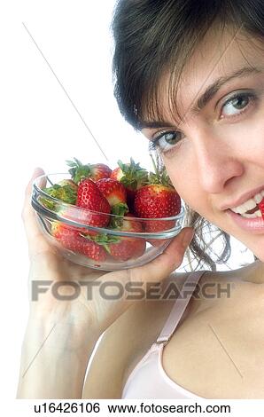 Stock Photograph - Woman, Brown Hair, Beauty, White undershit, Eating, Fruit, Strawberry. Fotosearch