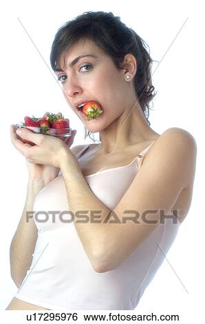 Stock Photograph - Woman, Brown Hair, Beauty, White undershit, Eating, Fruit, Strawberry. Fotosearch