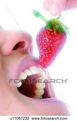Stock Image - Woman, Beauty, Eating, Fruit, Strawberry, Mouth, Opening mouth. Fotosearch