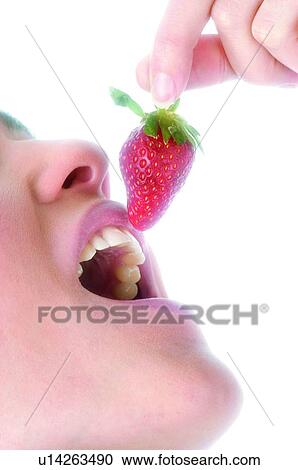 Stock Image - Woman, Beauty, Eating, Fruit, Strawberry, Mouth, Opening mouth. Fotosearch