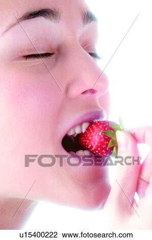 Stock Image - Woman, Beauty, Eating, Fruit, Strawberry, Mouth, Opening mouth. Fotosearch