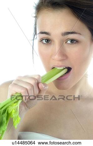 Picture - Woman, Beauty, Eating, Vegetable, Leek, Mouth, Opening mouth. Fotosearch