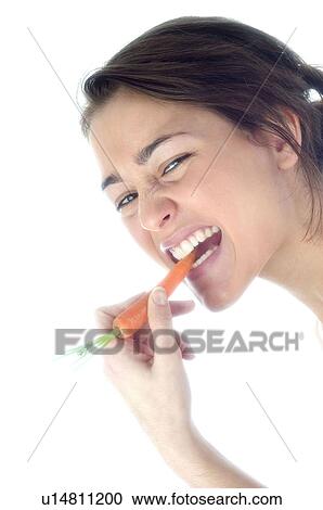Stock Image - Woman, Beauty, Eating, Vegetable, Carrot, Mouth, Opening mouth. Fotosearch