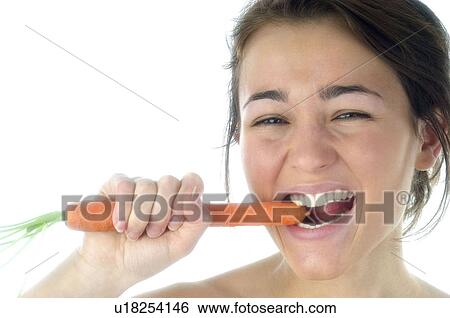Stock Photograph - Woman, Beauty, Eating, Vegetable, Carrot, Mouth, Opening mouth. Fotosearch