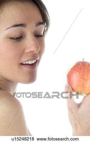 Stock Photo - Woman, Beauty, Smiling, Fruit, Apple, Mouth, Face. Fotosearch