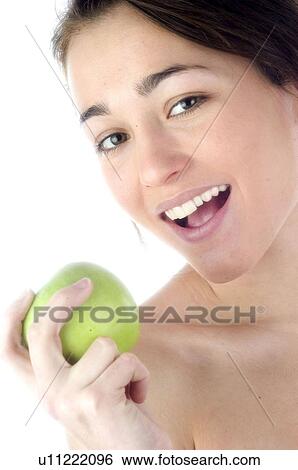 Stock Photograph - Woman, Beauty, Smiling, Fruit, Apple, Mouth, Face. Fotosearch