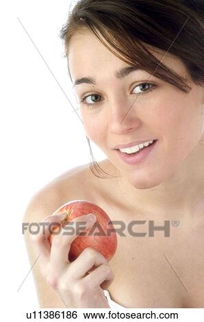 Stock Photograph - Woman, Beauty, Smiling, Fruit, Apple, Mouth, Face. Fotosearch