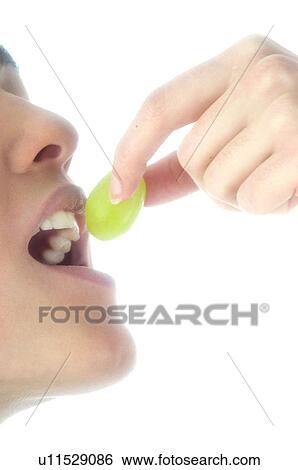 Stock Photograph - Woman, Beauty, Smiling, Fruit, Grape, Mouth, Face. Fotosearch