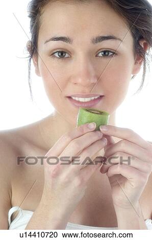 Stock Image - Woman, Beauty, Smiling, Fruit, Kiwi, Mouth, Face. Fotosearch