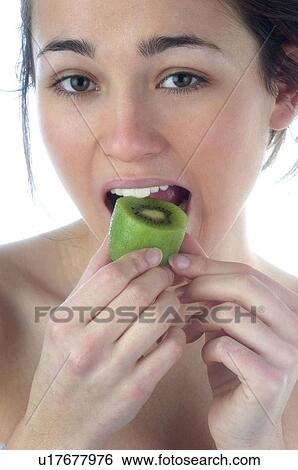 Stock Photograph - Woman, Beauty, Smiling, Fruit, Kiwi, Mouth, Face. Fotosearch