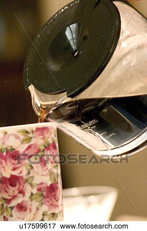 Stock Photo - Pouring brewed coffee into a flowered mug. Fotosearch