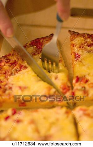 Picture - Cutting pizza. Fotosearch