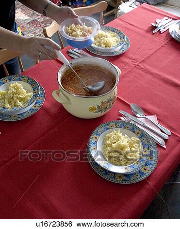 Stock Photograph - Serving Polish Sunday dinner of tomato soup and pasta. Fotosearch