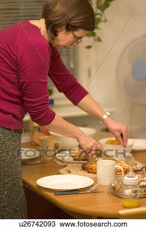 Woman cutting pizza for dinner View Large Photo Image Stock Image - Woman cutting pizza for dinner. Fotosearch