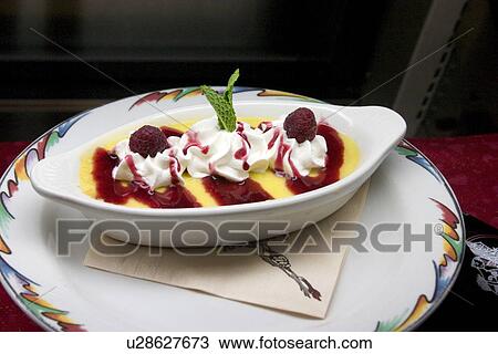 Stock Image - Enjoy fine dining with a Raspberry dessert. Fotosearch