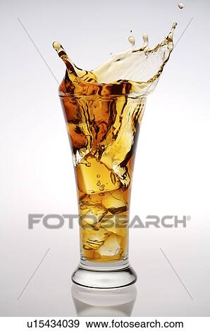 Glass of iced black tea, splashing out of the glass View Large Photo Image Stock Photo - Glass of iced black tea, splashing out of the glass. Fotosearch