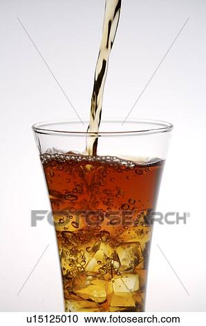 Iced black tea being poured into a glass with ice cubes View Large Photo Image Stock Image - Iced black tea being poured into a glass with ice cubes. Fotosearch
