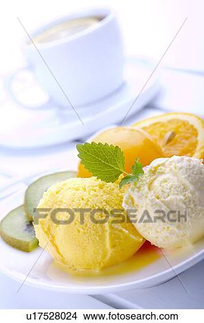 Picture - Plate of ice cream with fruit and garnish. Fotosearch