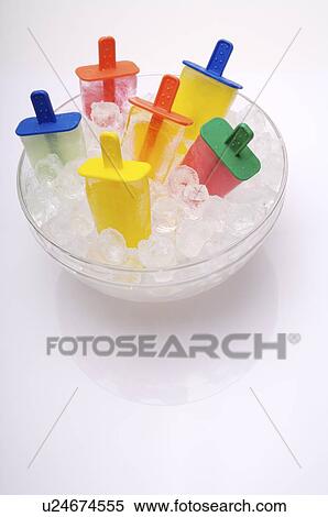 Stock Photography - Popsicles sticking out from a bowl of ice cubes. Fotosearch