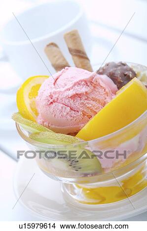 Strawberry ice cream in a cup with cookies, chocolate, and fruit garnish View Large Photo Image Picture - Strawberry ice cream in a cup with cookies, chocolate, and fruit garnish. Fotosearch