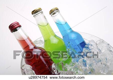 Picture - Three bottles of cocktail drink, half covered with ice cubes. Fotosearch