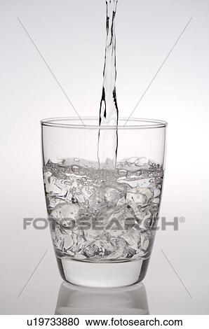 Water being poured into a glass filled with ice, from above View Large Photo Image Stock Image - Water being poured into a glass filled with ice, from above. Fotosearch