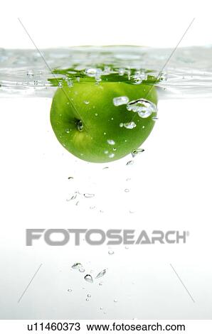 A green apple dropping into water, with water bubbles View Large Photo Image Stock Image - A green apple dropping into water, with water bubbles. Fotosearch
