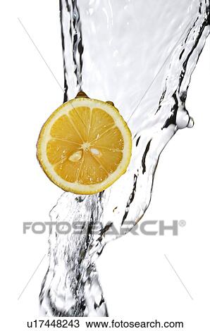Stock Image - Cross-section of an orange amount a stream of water. Fotosearch