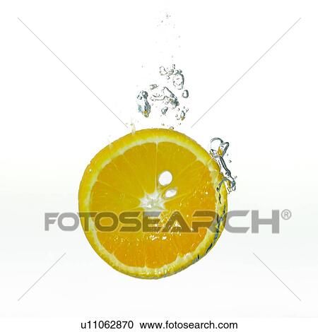 Stock Image - Cross-section of an orange in water, with water bubbles. Fotosearch
