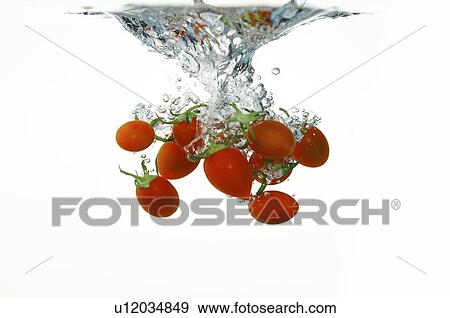 Fresh cherry tomatoes falling into water View Large Photo Image Stock Photo - Fresh cherry tomatoes falling into water. Fotosearch