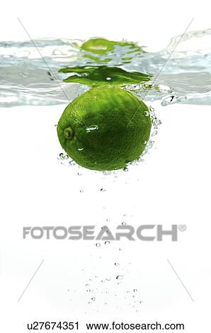 Green lemon floating in water View Large Photo Image Stock Image - Green lemon floating in water. Fotosearch
