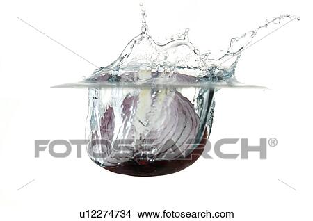 Picture - Half an onion falling into water, splashing water upwards. Fotosearch