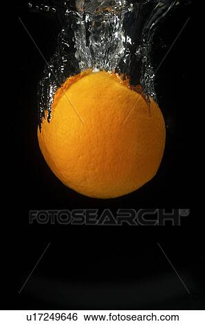 Stock Photograph - Orange falling into water. Fotosearch
