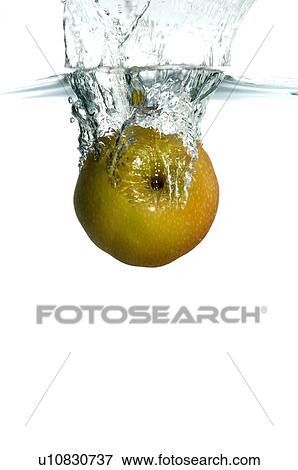 Stock Photo - Pear falling into water, splashing water upwards. Fotosearch