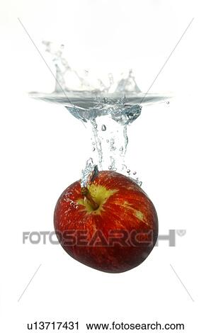 Red apple falling into a glass of water View Large Photo Image Stock Image - Red apple falling into a glass of water. Fotosearch