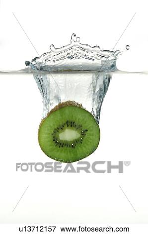 Sliced kiwi fruit splashing into water View Large Photo Image Stock Photo - Sliced kiwi fruit splashing into water. Fotosearch
