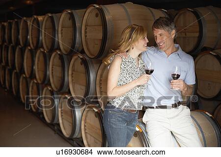 Couple drinking red wine in wine cellar View Large Photo Image Picture - Couple drinking red wine in wine cellar. Fotosearch