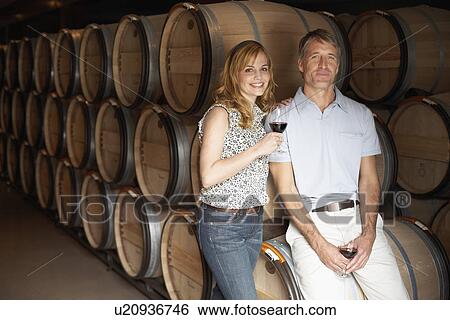 Couple drinking red wine in wine cellar (portrait) View Large Photo Image Stock Photograph - Couple drinking red wine in wine cellar (portrait). Fotosearch