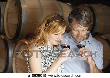 Stock Photography - Couple smelling red wine. Fotosearch