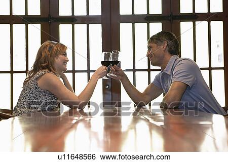 Couple toasting View Large Photo Image Stock Photograph - Couple toasting. Fotosearch