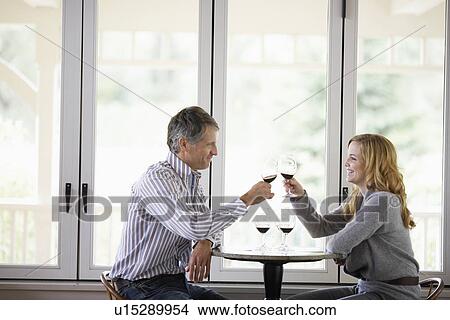 Couple toasting with red wine View Large Photo Image Picture - Couple toasting with red wine. Fotosearch