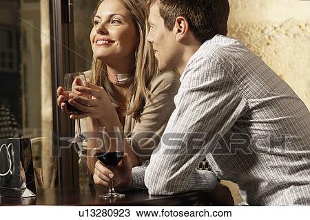 Mid adult couple drinking red wine in restaurant View Large Photo Image Stock Image - Mid adult couple drinking red wine in restaurant. Fotosearch