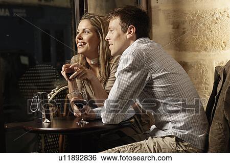 Mid adult couple drinking red wine in restaurant View Large Photo Image Stock Photograph - Mid adult couple drinking red wine in restaurant. Fotosearch
