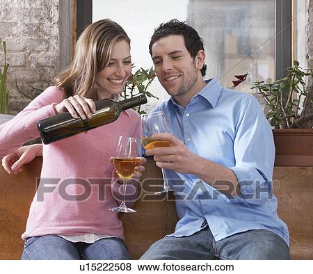 Stock Photo - Mid-Adult Couple Drinking White Wine. Fotosearch