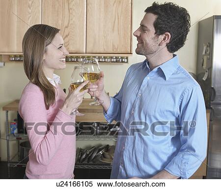 Stock Photography - Mid-Adult Couple Toasting with White Wine. Fotosearch